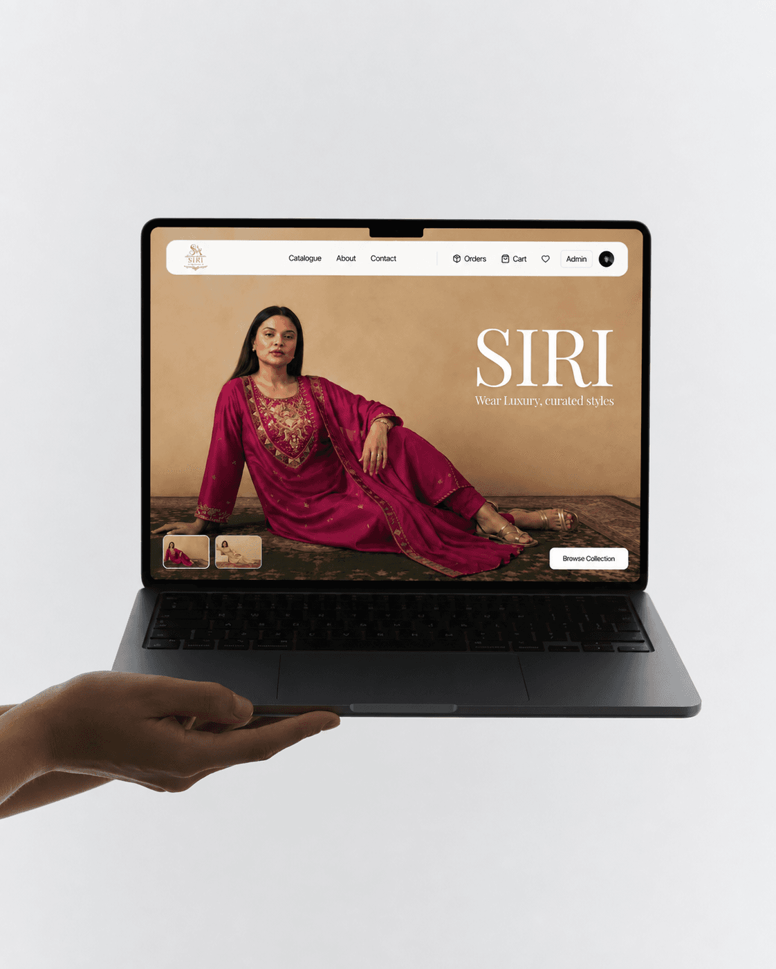 A hand holding a laptop that shows the SIRI online store