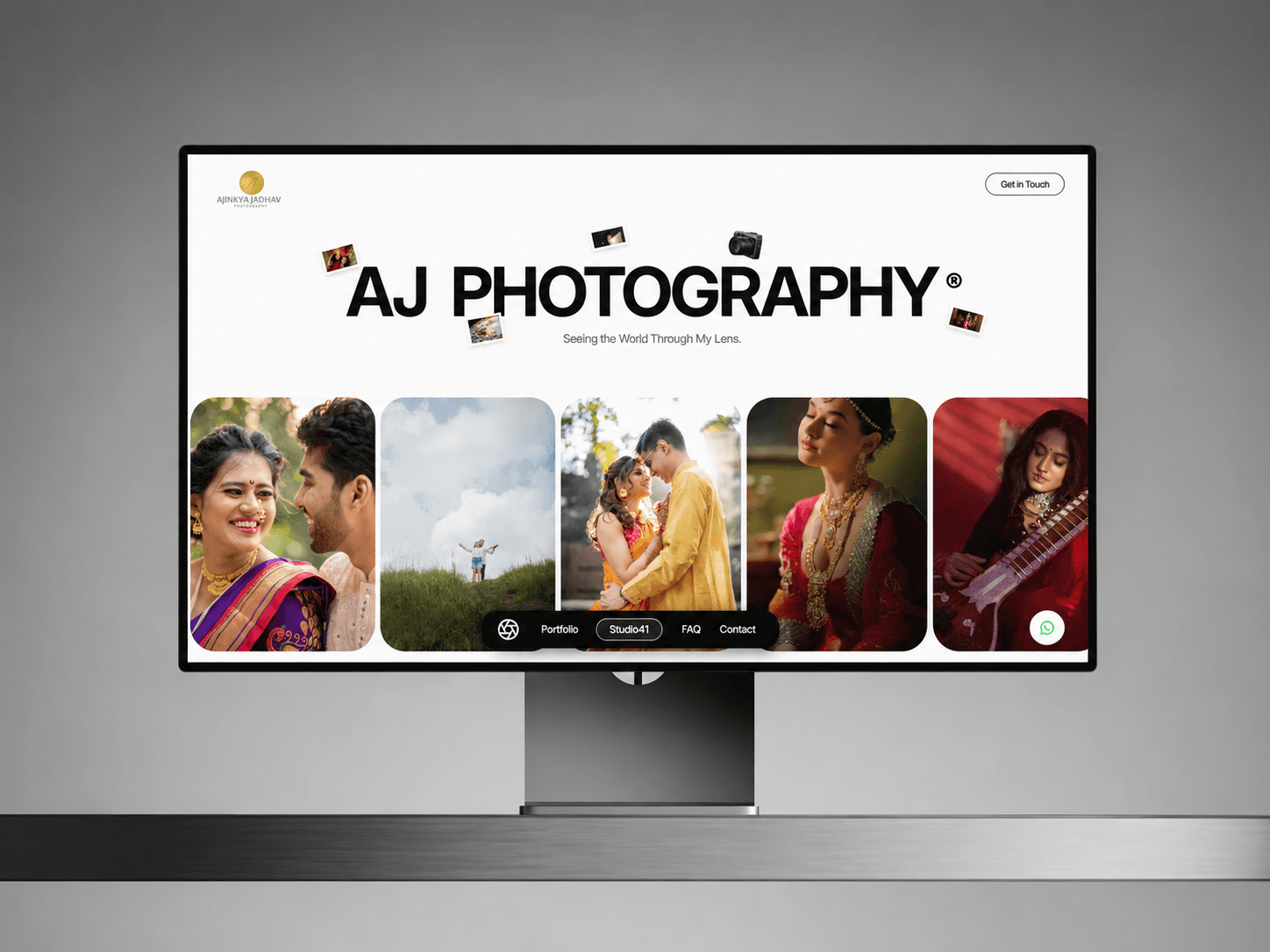 AJ Photography home page on a desktop monitor, with a row of portrait and wedding photographs
