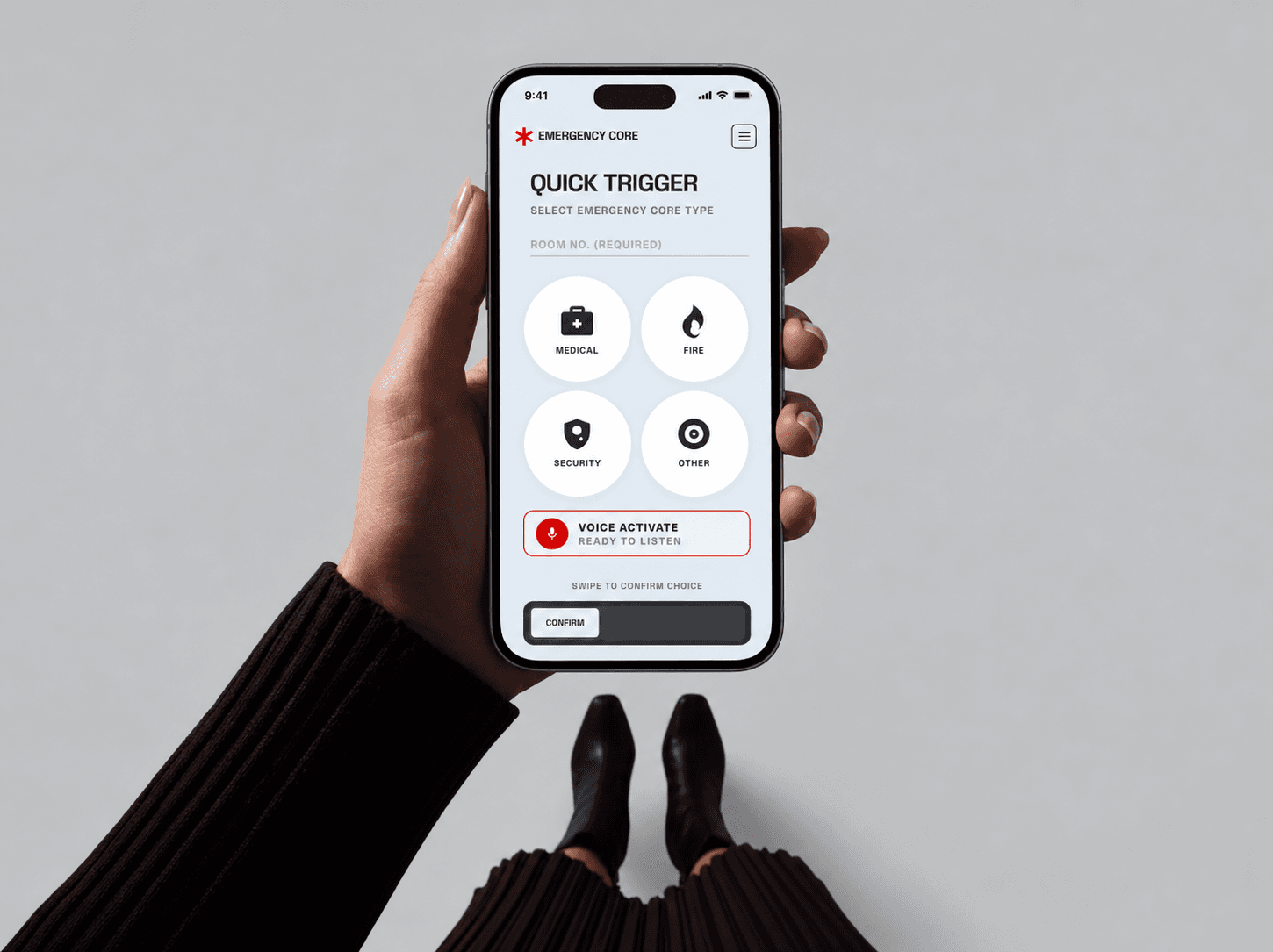A hand holding a phone showing the quick-trigger screen, with medical, fire, security and other buttons